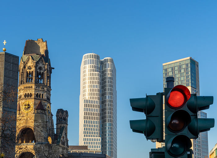 Stop light against city skyline