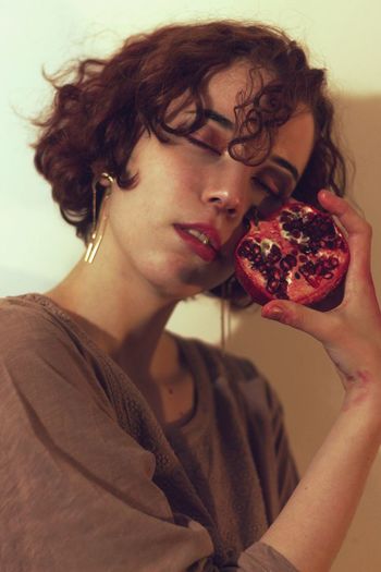 Close-up woman holding pomegranates