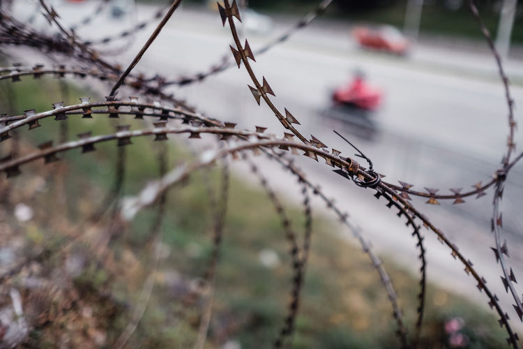 Close up of barbed wire fencing in a city
