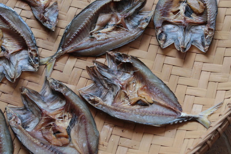 High angle view of dried fish on wicker plate