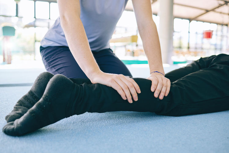 Low section of woman exercising on floor
