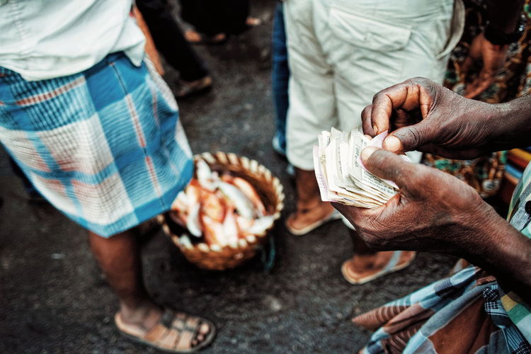 Low section of vendor holding currency