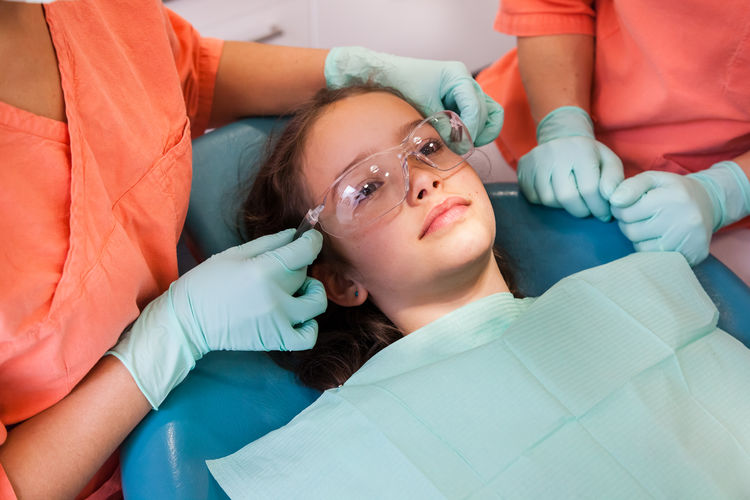 Smiling girl getting dental treatment