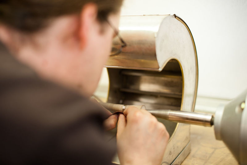 Close-up of goldsmith working on ring