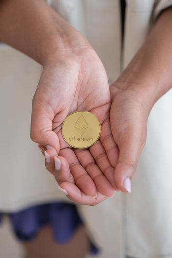 Unrecognizable black girl holding cryptocurrency with hands