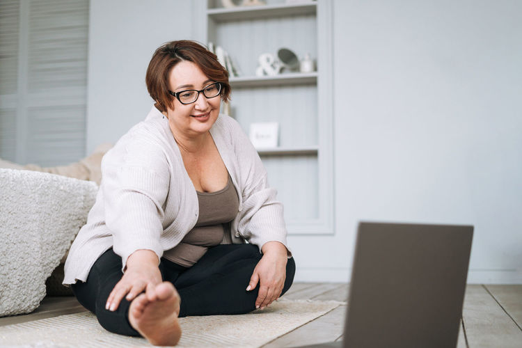 Young woman using laptop while sitting at home