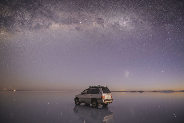 Car over the water under the stars