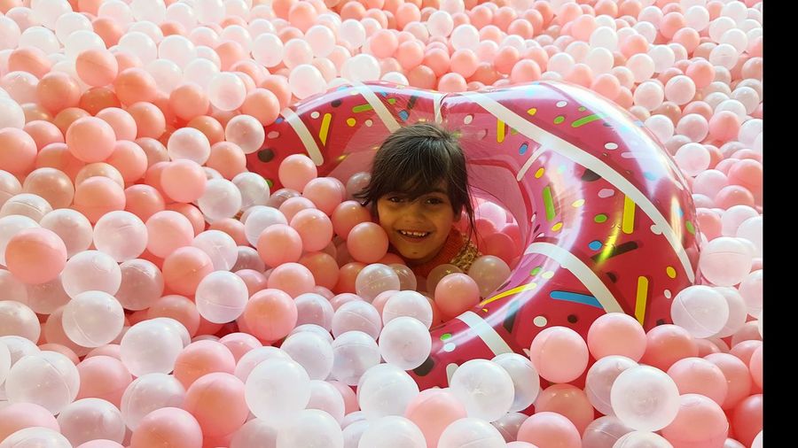 Portrait of smiling girl amidst ball pool