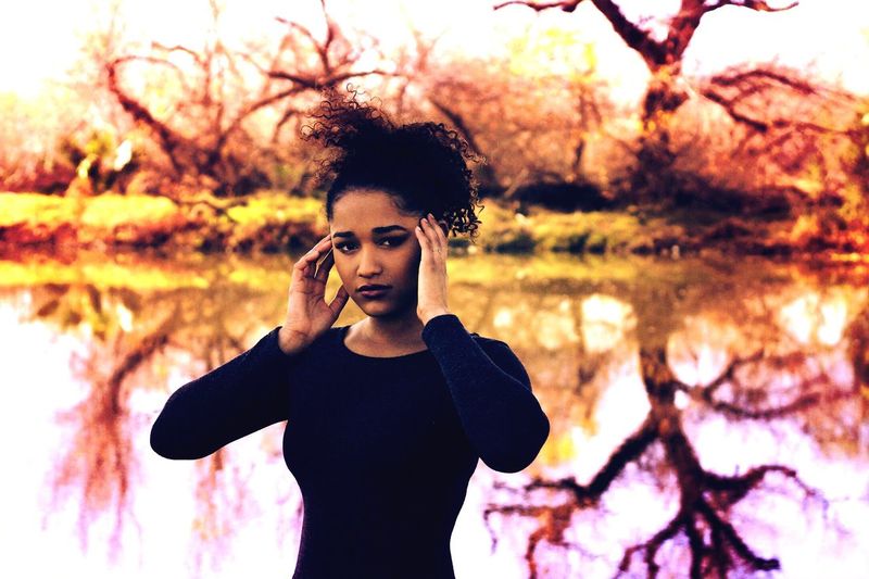 Portrait of a black woman by a lake