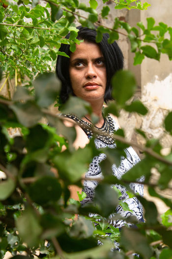 Portrait of woman against plants