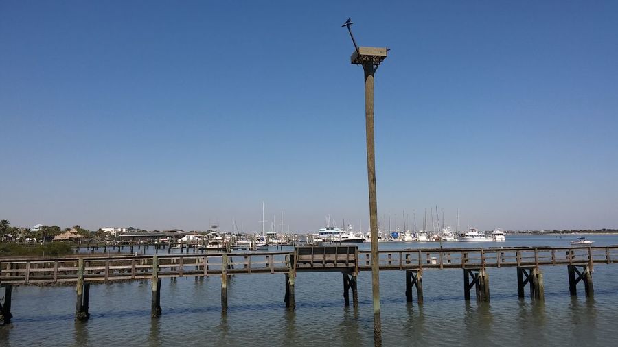 Harbor against clear blue sky