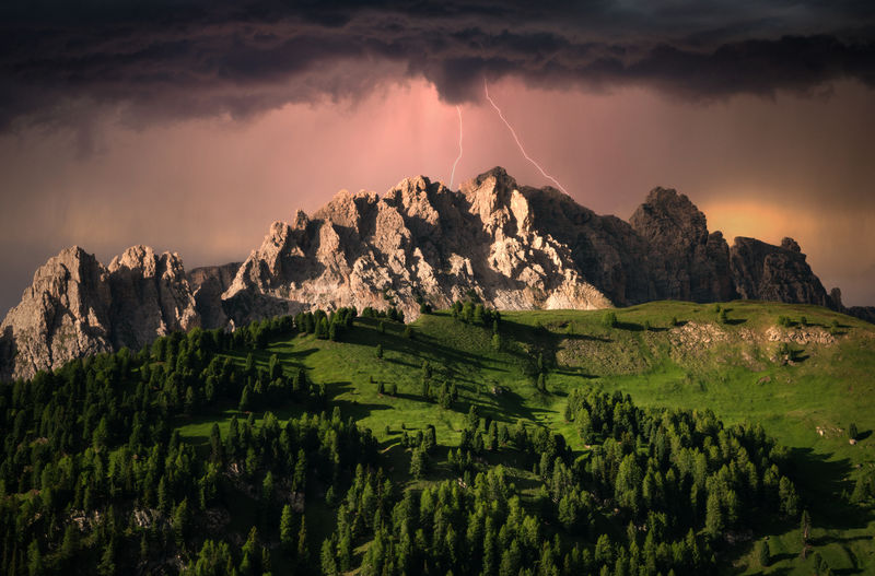 Dramatic clouds and lightning over mountain in dolomite, italy