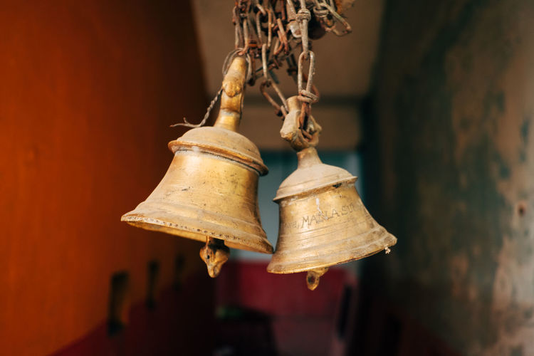 Close-up of bell hanging against wall