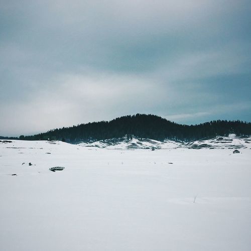 Idyllic shot of snow covered landscape against sky at baramulla
