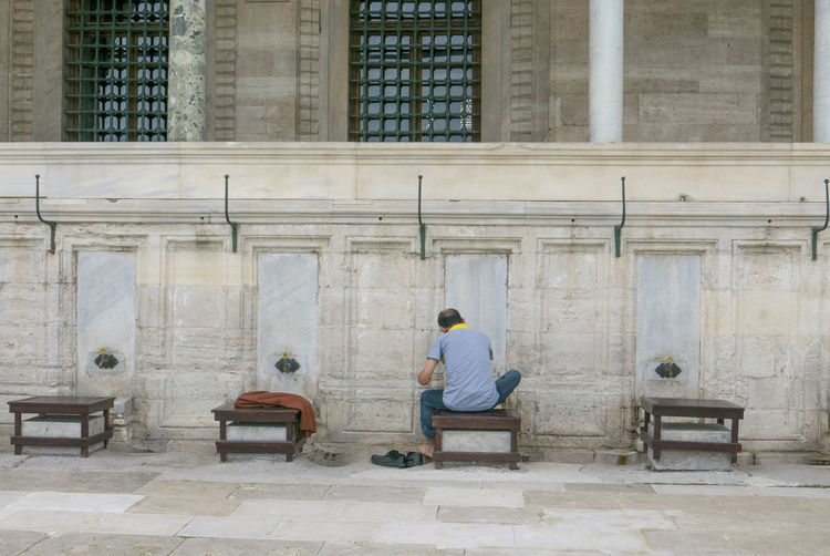 Unidentified muslim man takes ablution before a prayer at suleimaniye mosque in istanbul, turkey.