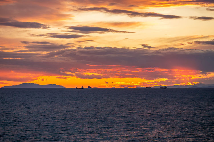 Scenic view of sea against romantic sky at sunset