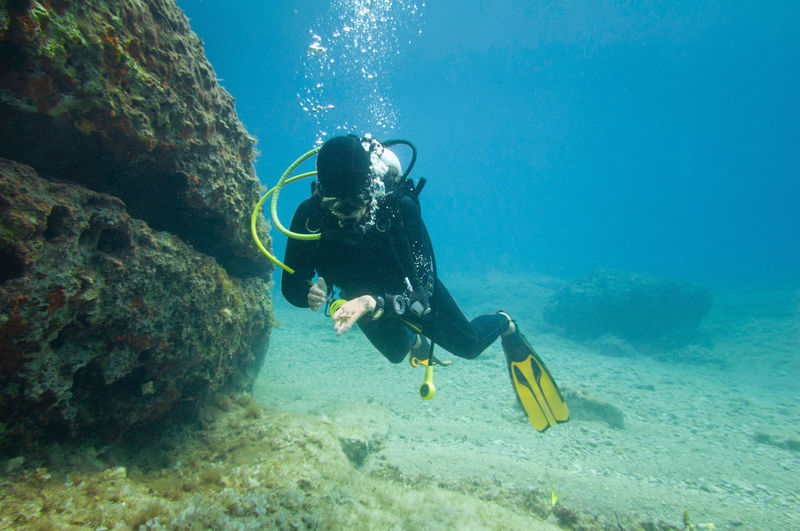 Woman scuba diving in sea