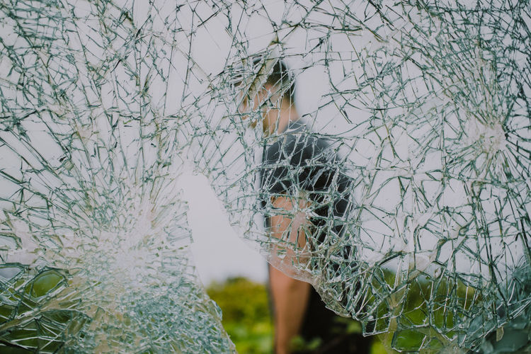 Man seem through shattered glass