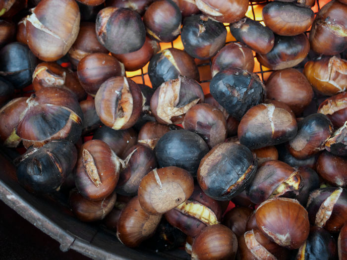 Directly above shot of chestnuts roasting on container