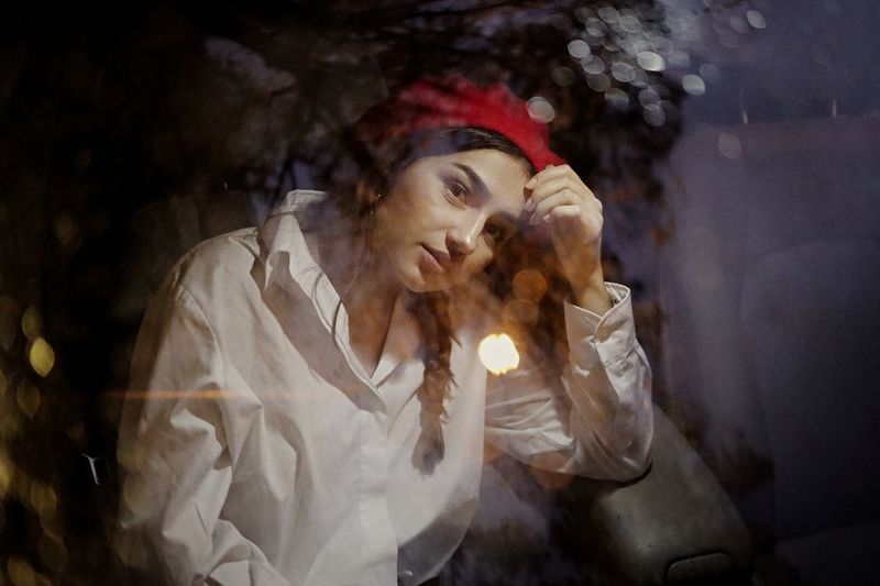 Digital composite image of woman in a car