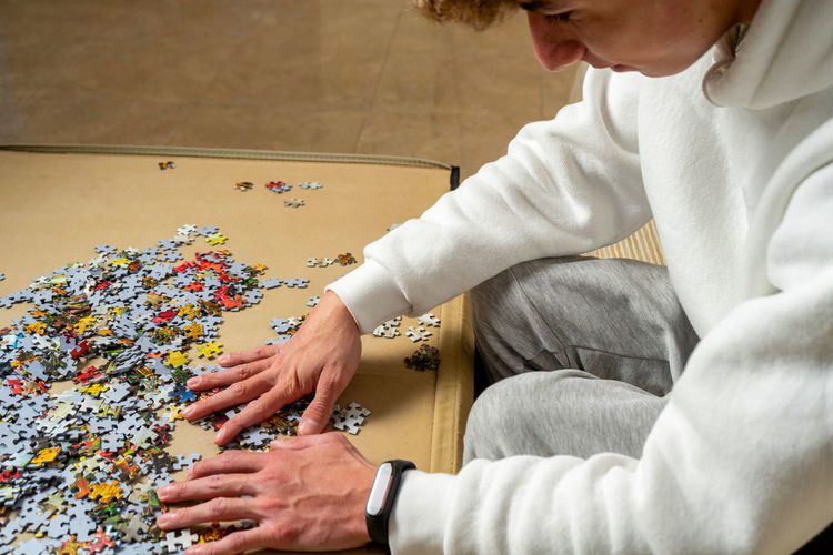 Midsection of woman holding jigsaw pieces