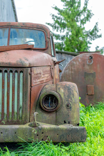 Old rusty car against sky