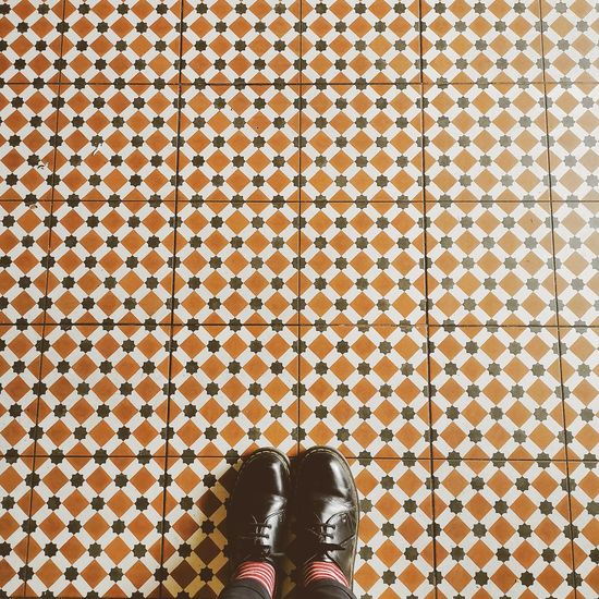 Low section of girl standing on tiled floor