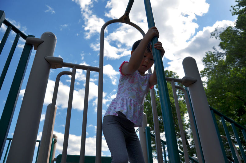 Low angle view of child playing in playground