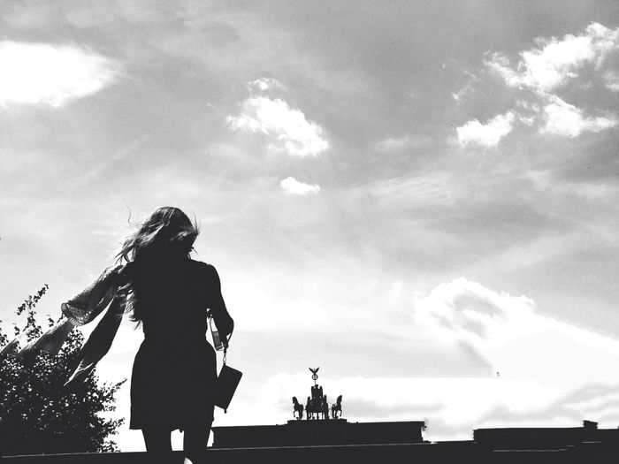 Silhouette woman walking against the sky