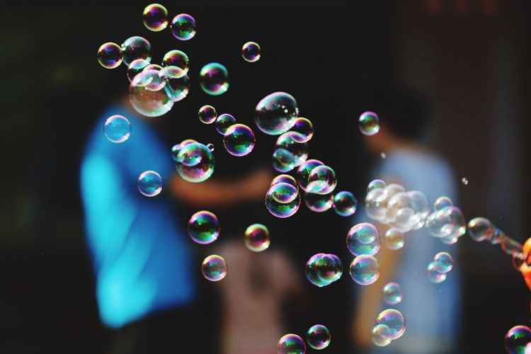 Bubbles in mid-air against people