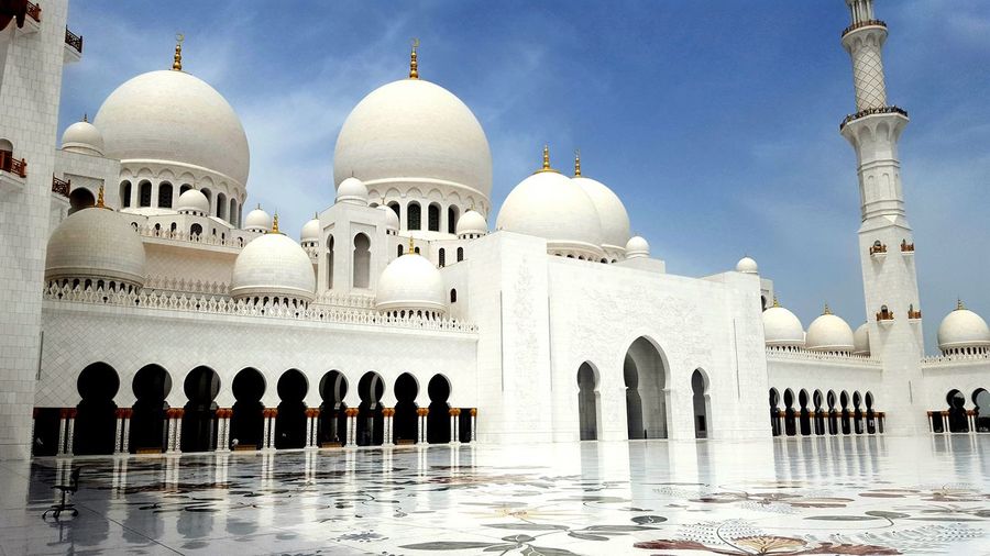 Low angle view of sheikh zayed mosque against sky on sunny day