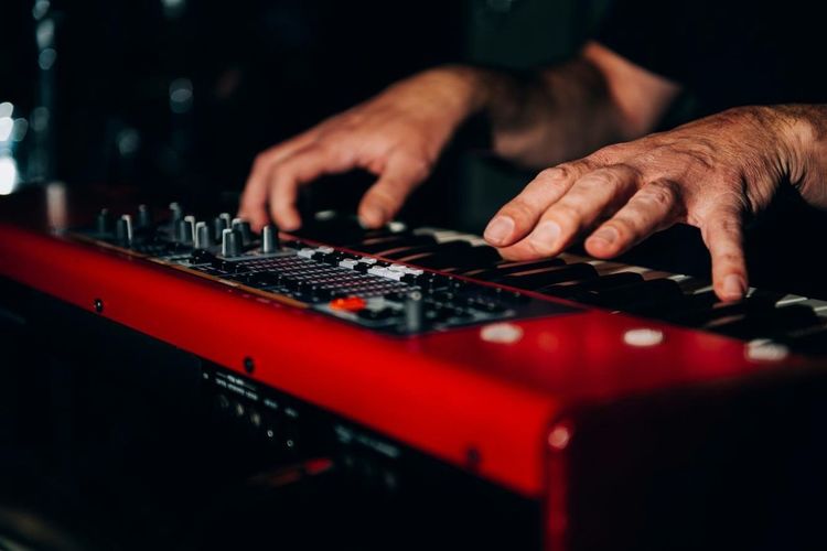 Cropped image of hand playing piano