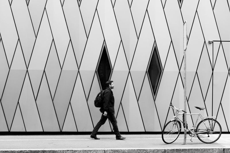 Man walking on bicycle in city