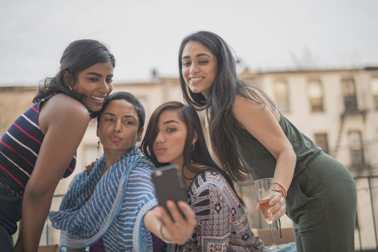 Young women taking a selfie at a party together