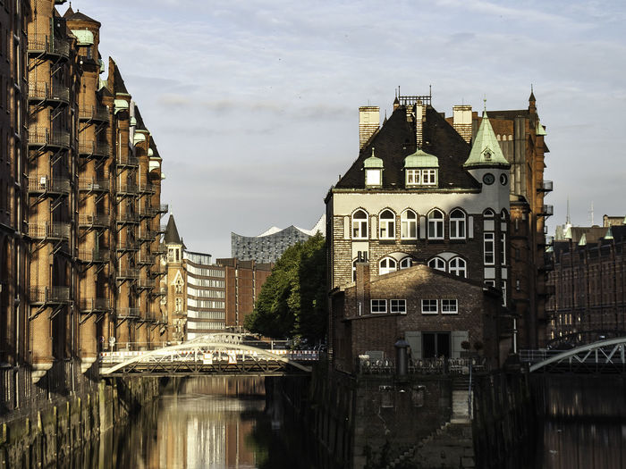 Buildings reflecting on canal at speicherstadt