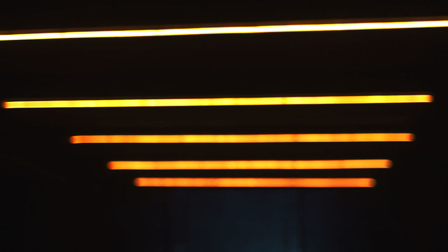Close-up of yellow lights against black background