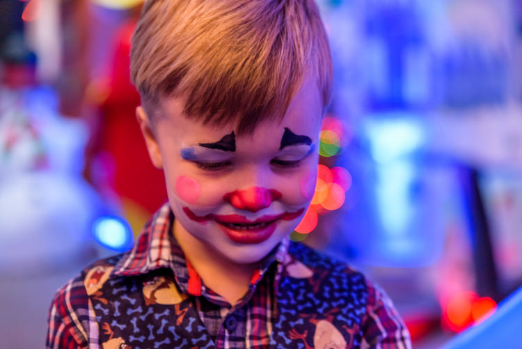 Close-up of child with clown make-up