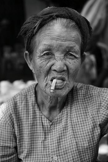 Close-up portrait of woman smoking bidi