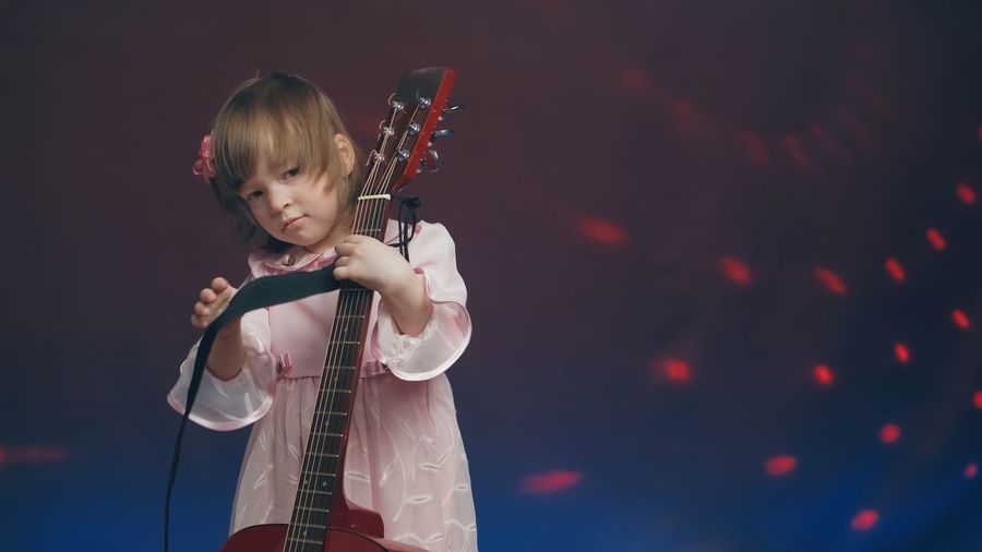 Portrait of boy playing guitar