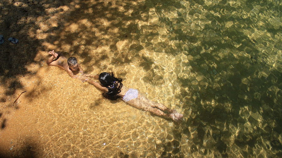 High angle view of people relaxing on beach
