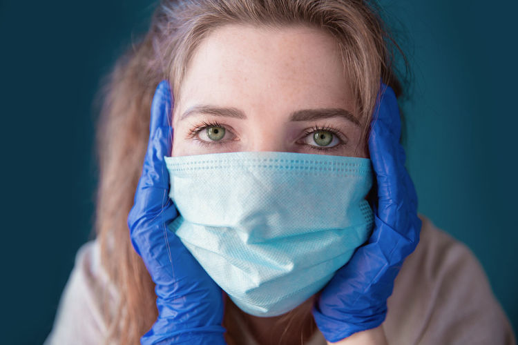 Close-up of woman wearing mask and gloves