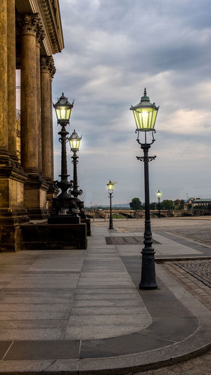Street light in city against sky