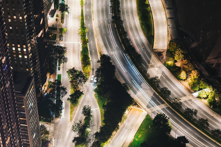High angle view of light trails on overpass road in city