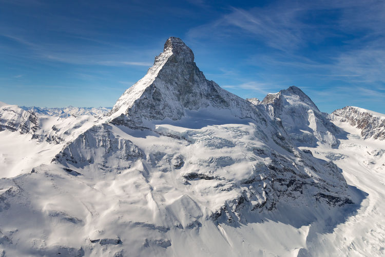 Scenic view of snow covered mountains against sky
