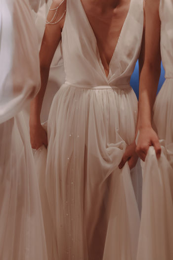 Cropped figures of women dressed in a wedding dress. airy fabric. fluffy skirt.
