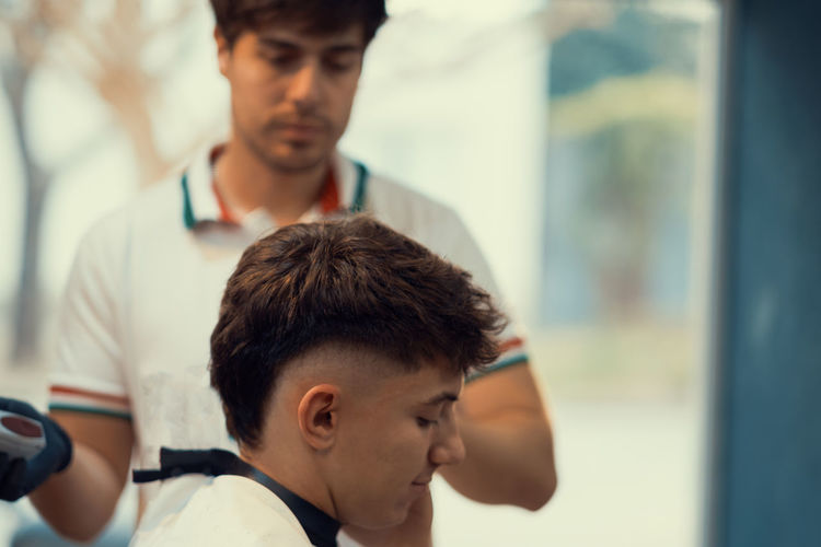 Portrait of hairdresser teenager haircut