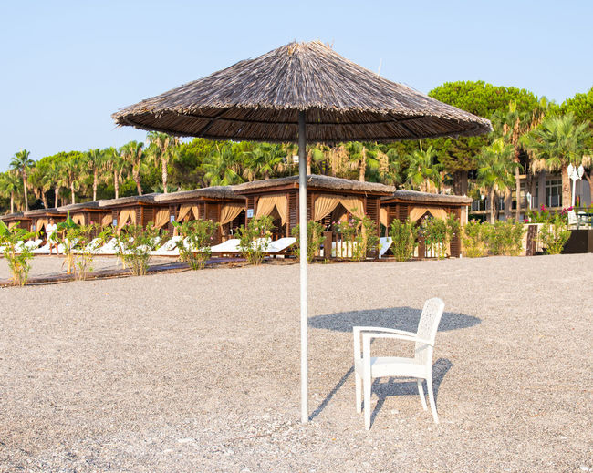Chairs and tables against clear sky