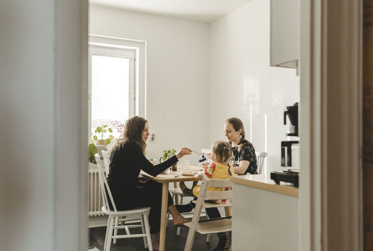 Family with daughter sitting at table