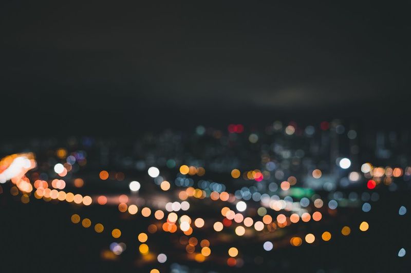 Defocused image of illuminated city at night