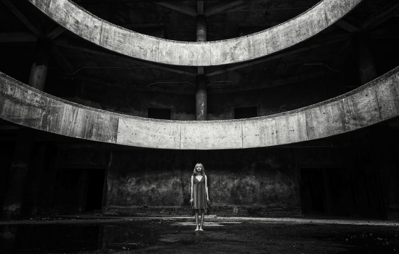 Woman standing in abandoned building